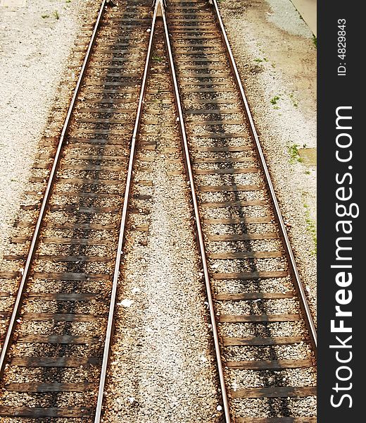 Railroad tracks crossing in perspective