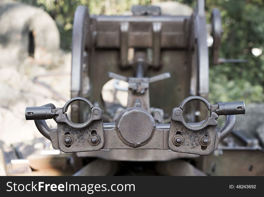 An old WWII turret or anti aircraft rests at the top of a mountain in Luang Prabang - looking down the barrel