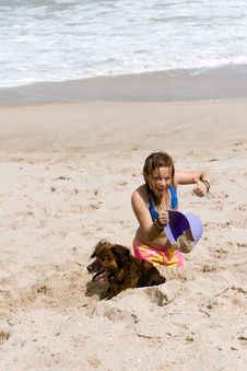 Girl In The Sand With Bucket And Dog Stock Photography Girl In The Sand With Bucket And Dog Stock Photography