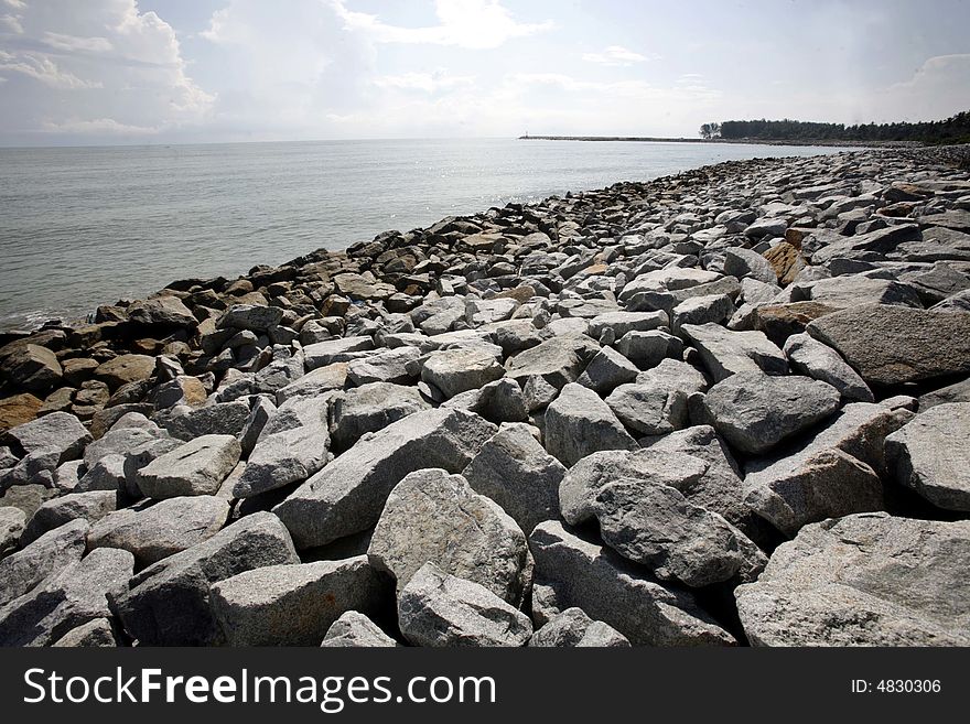 A stone embankment at a sea coast.