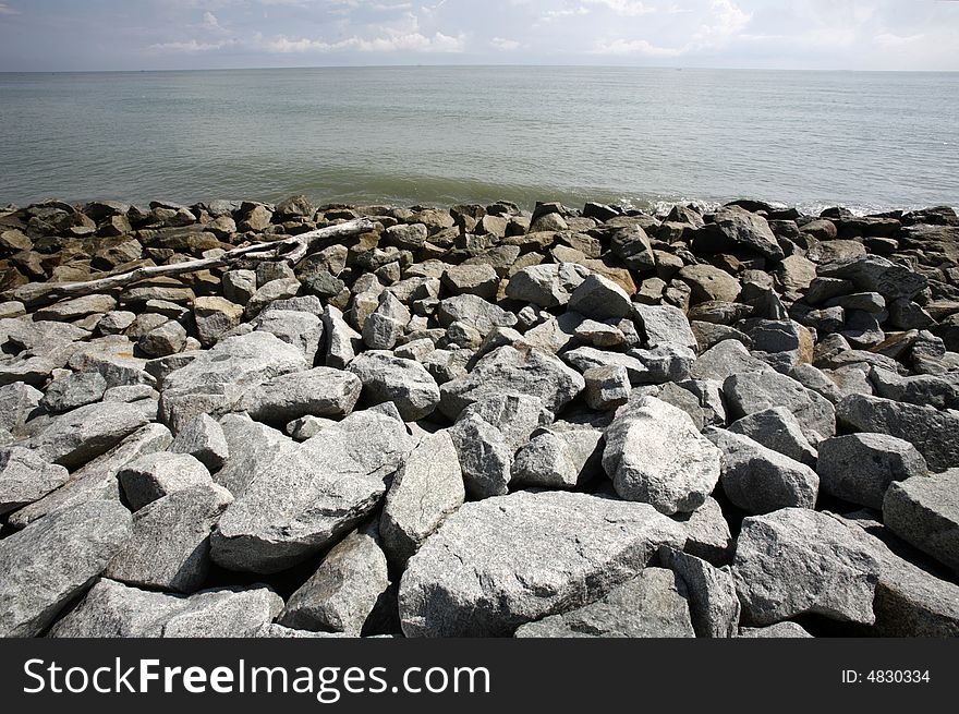 A stone embankment at a sea coast.