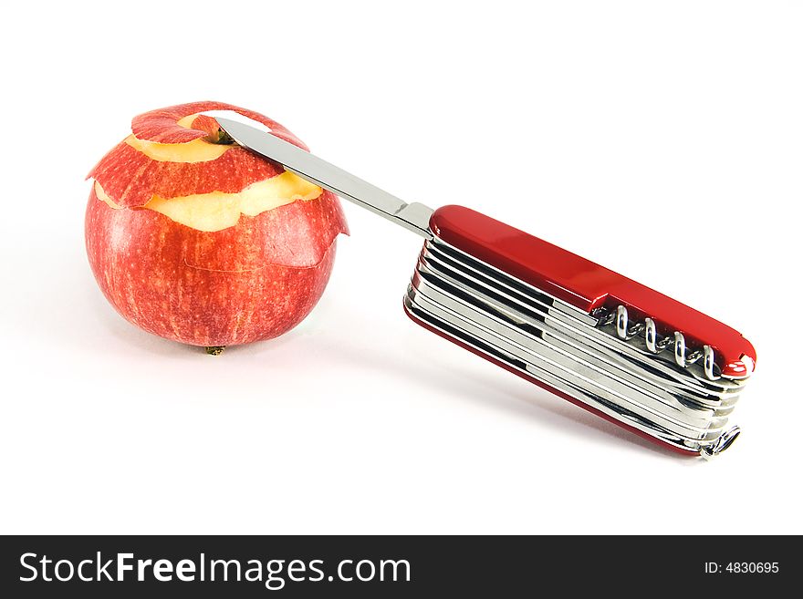 Pocket knife and partially peeled apple,on white background