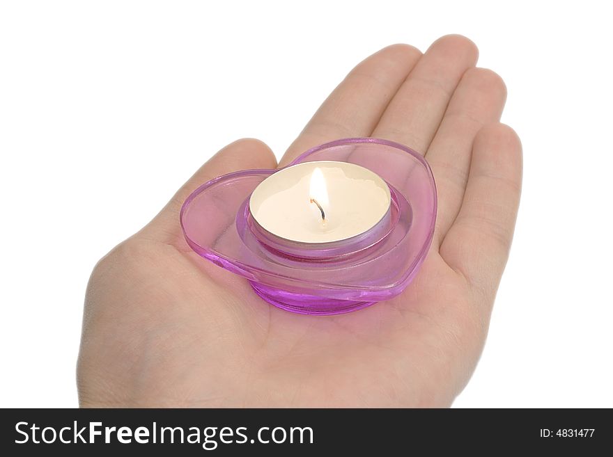 A magenta candlestick on the hand isolated over white. A magenta candlestick on the hand isolated over white