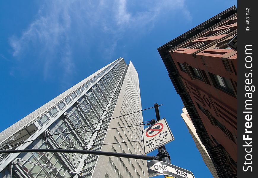 Contrast between an old stone and brick building and a gleaming steel, glass and concrete skyscraper in New York City. Contrast between an old stone and brick building and a gleaming steel, glass and concrete skyscraper in New York City