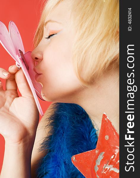 Girl kissing butterfly. Focus on the lips