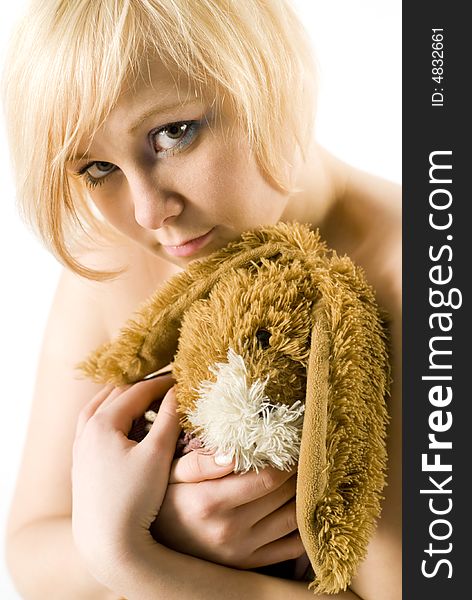 Girl with rabbit-toy looking at camera