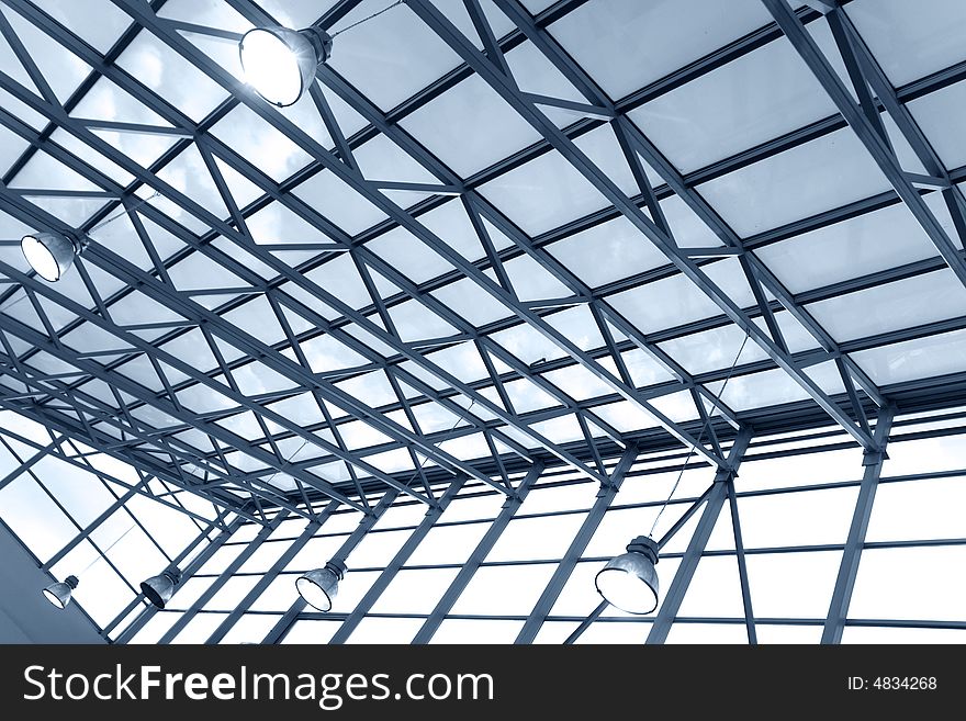 Steel ceiling with windows and lamps in a modern business center (toned blue). Steel ceiling with windows and lamps in a modern business center (toned blue)