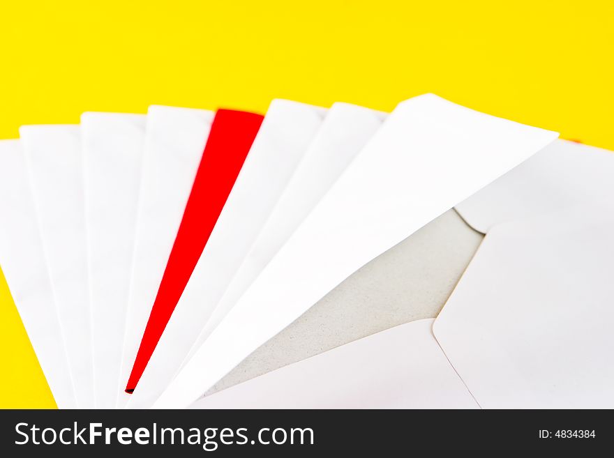 One red and seven white envelopes on a yellow background. One red and seven white envelopes on a yellow background