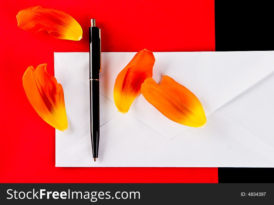 Pen And Petals On A White Envelope