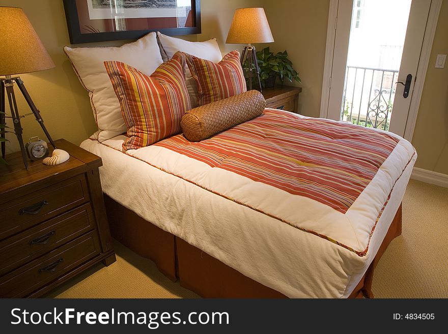 Comfortable bedroom in a luxury home with stylish decor. Comfortable bedroom in a luxury home with stylish decor.
