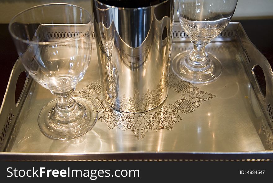 Silver tray with empty wine glasses.