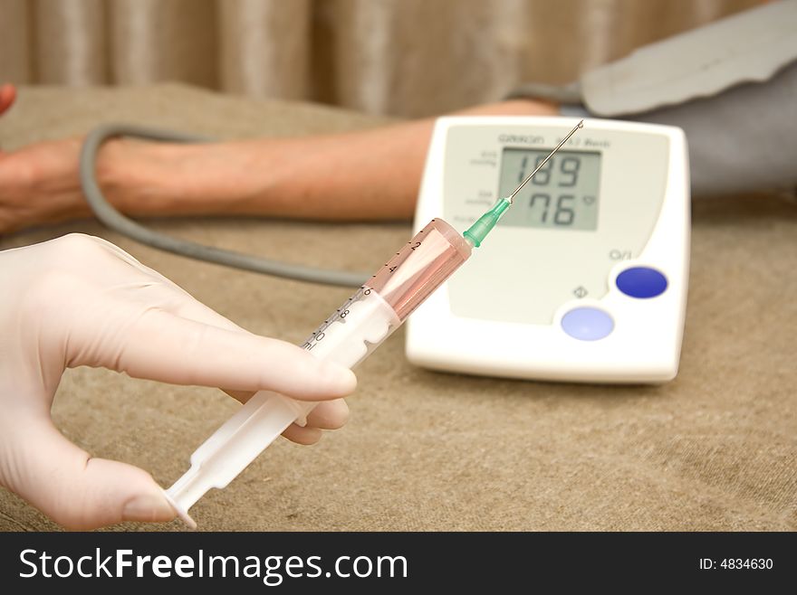 Medical assistance to patient with high blood pressure by giving an injection. Medical assistance to patient with high blood pressure by giving an injection