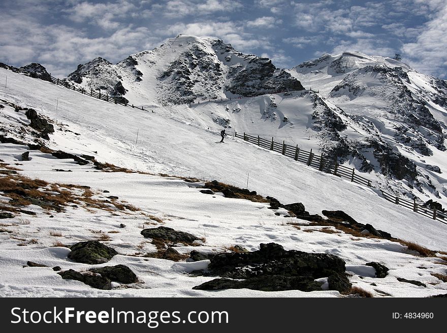 Skier skis down the wide mountain slopes. Skier skis down the wide mountain slopes