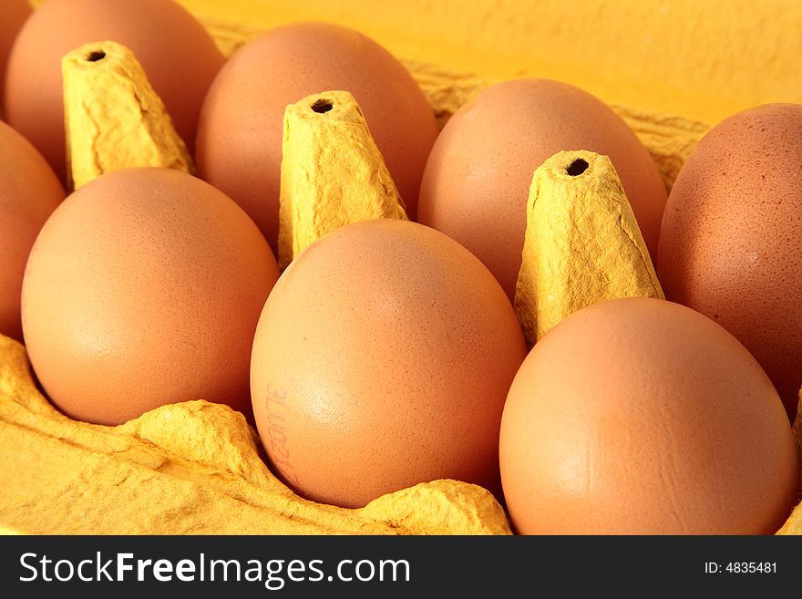 Eight eggs in a yellow box. Eight eggs in a yellow box