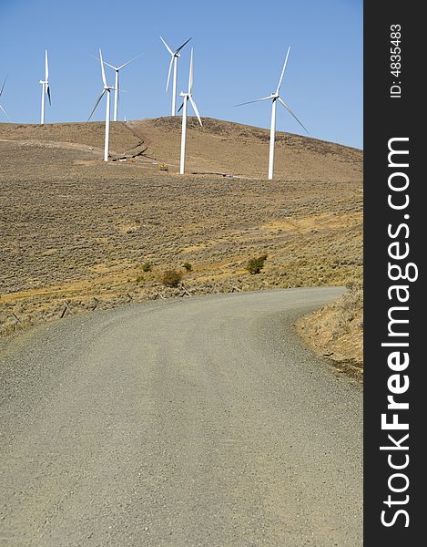 Gravel road among wind turbines.