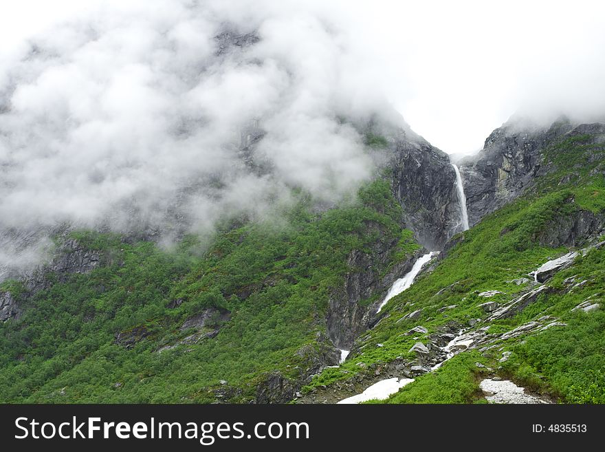 Fog in the mountains, waterfall, summer