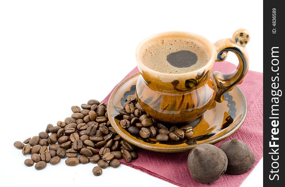 Coffee beans and black coffee in a cup isolated on a white background