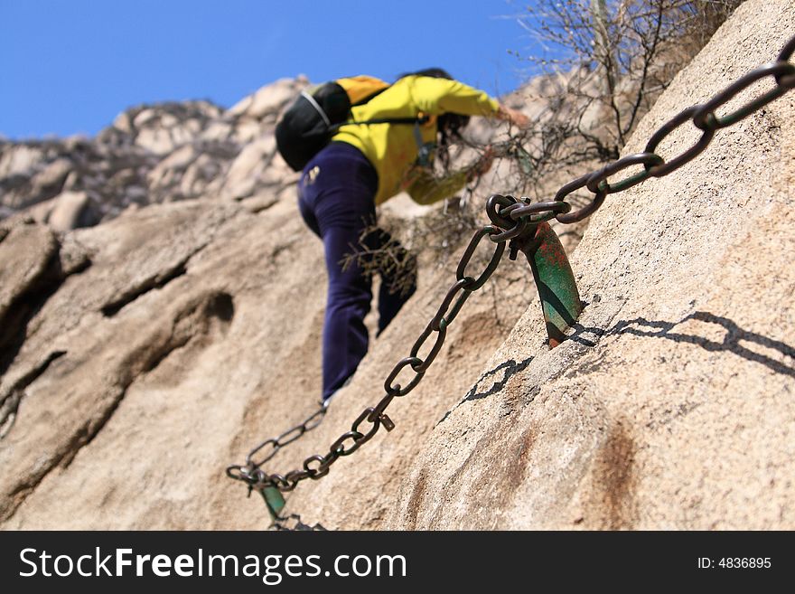 A young mountaineer steep Mountains