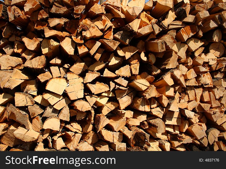 Background formed by a wall of chopped firewood. Background formed by a wall of chopped firewood