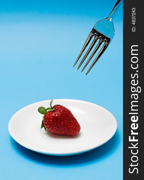 Strawberry with fork. Close up. Strawberry with fork. Close up.