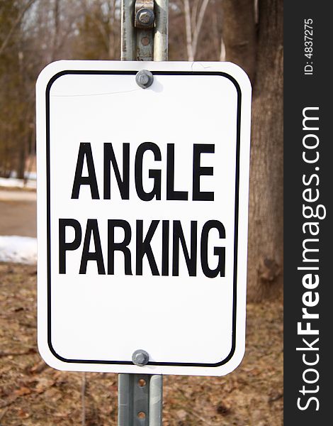 White angle parking traffic sign on a park