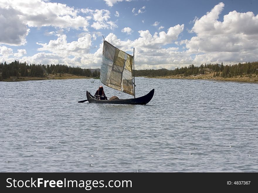 A poor man from southern India uses his old cloths and makes a sail. A poor man from southern India uses his old cloths and makes a sail