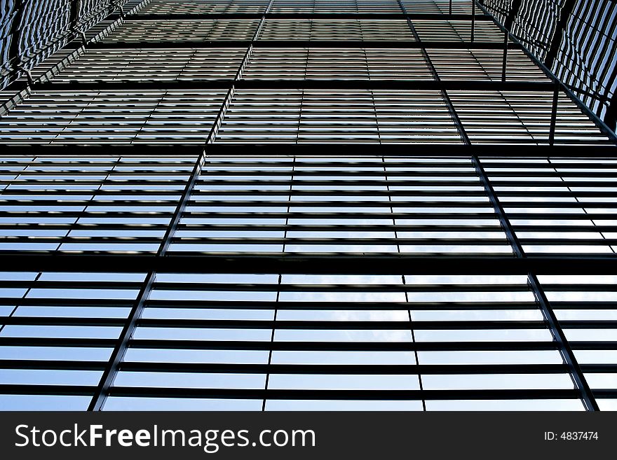 Abstract glass building facade with parallel metal details. Abstract glass building facade with parallel metal details