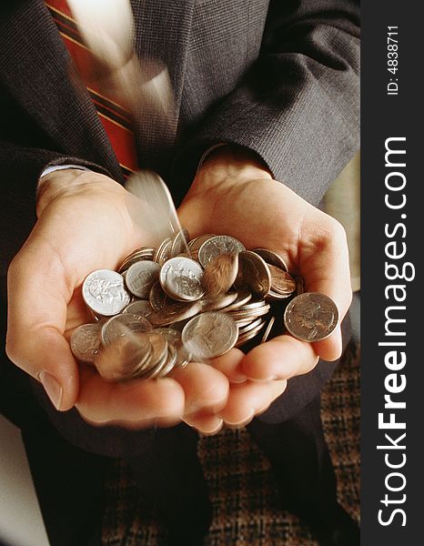 Man keeps in hands much placer metallic coins. Man keeps in hands much placer metallic coins