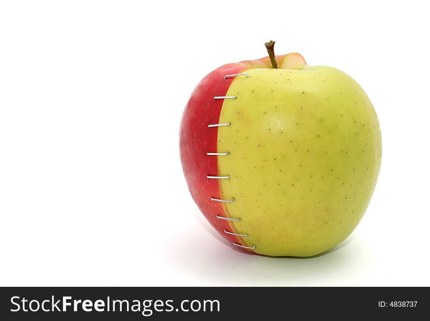 A red and a green apple stapled together. A red and a green apple stapled together