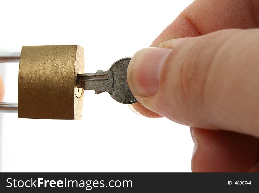 A hand opening a padlock with a key