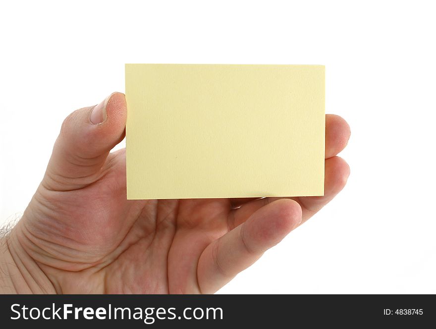 A hand holding a yellow paper. A hand holding a yellow paper