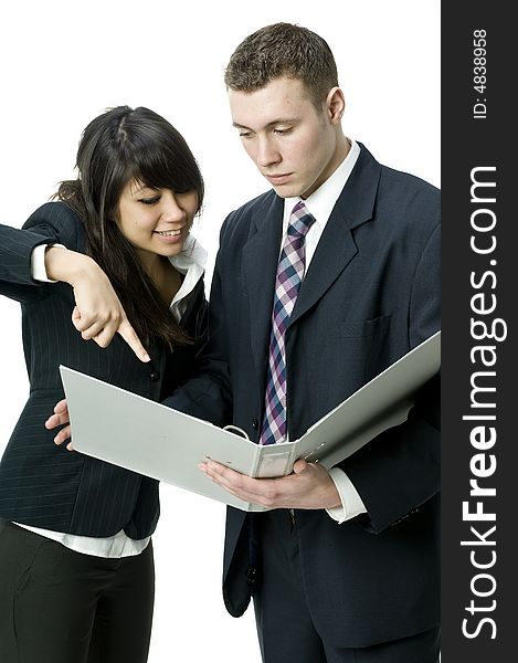 A young business couple sharing ideas over a file. A young business couple sharing ideas over a file