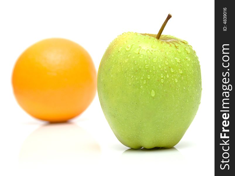 Orange and apple on white. Isolation.