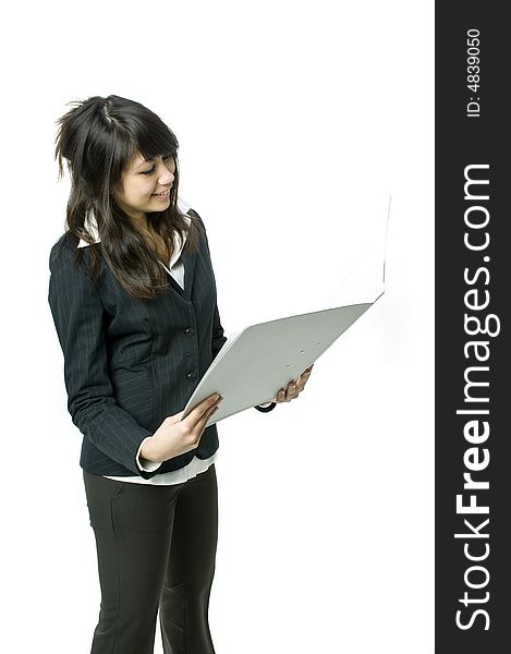 A young pretty businesswoman holding a file in the studio. A young pretty businesswoman holding a file in the studio