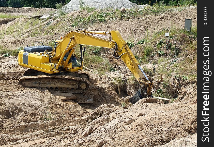 Excavator unloading concrete rubble on urban construction site