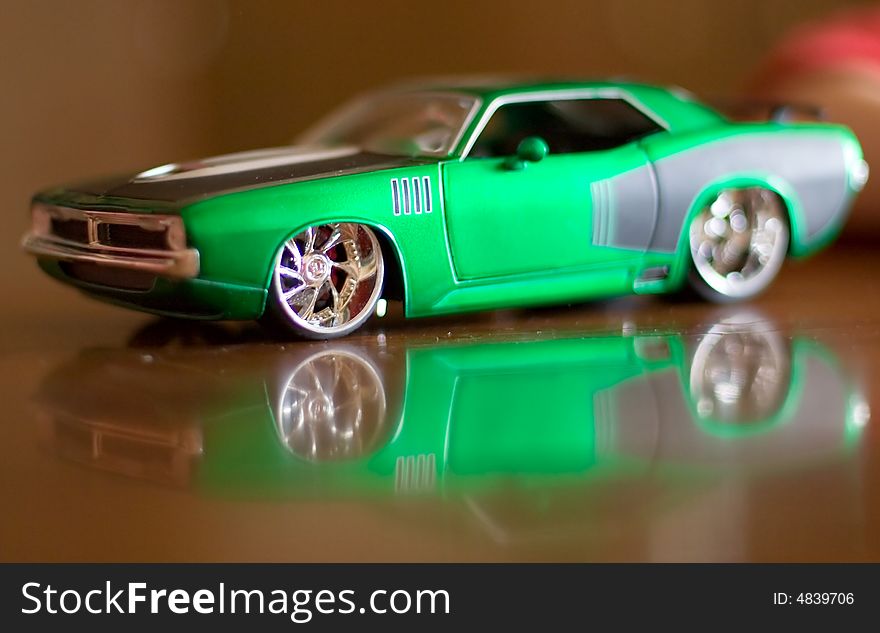 The reduced model of the ancient green car on a dark background