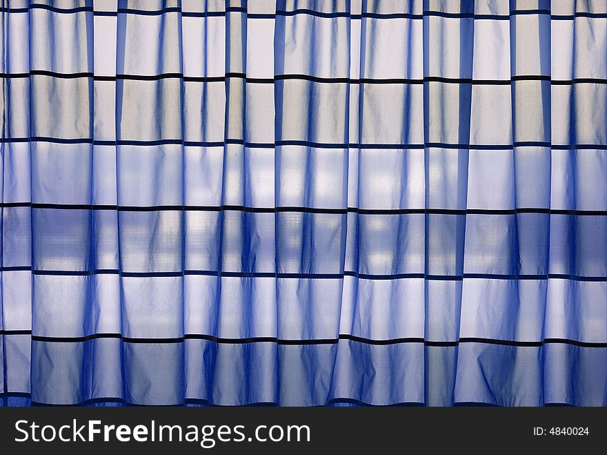 Blue stripped curtains helded in front of a window. Blue stripped curtains helded in front of a window