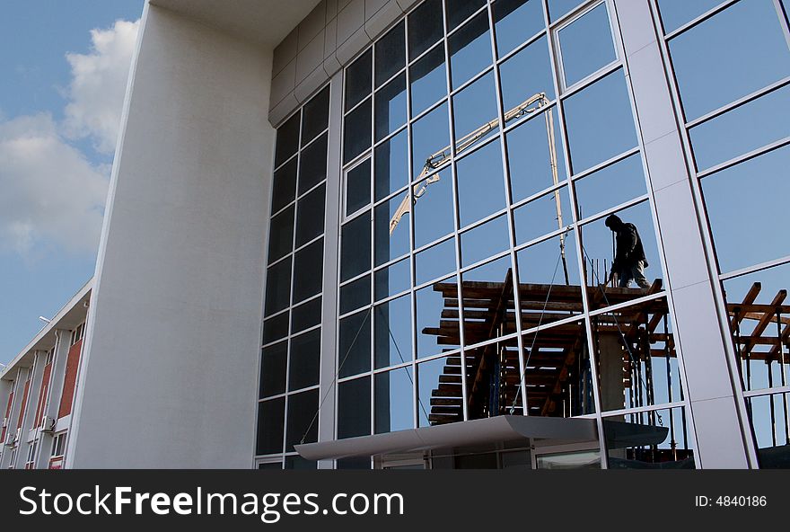 A worker in reflection on the windows