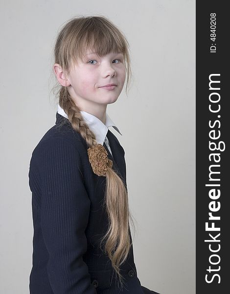 Funny school girl on neutral background