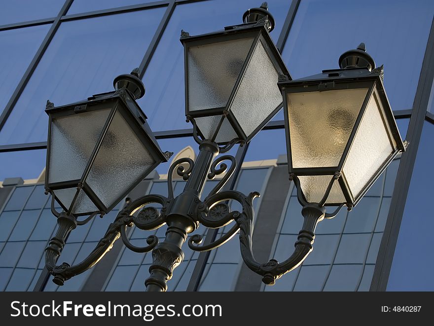 Old lanterns on the modern skyscraper background