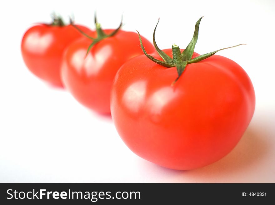 A photo of a three tomatoes. A photo of a three tomatoes