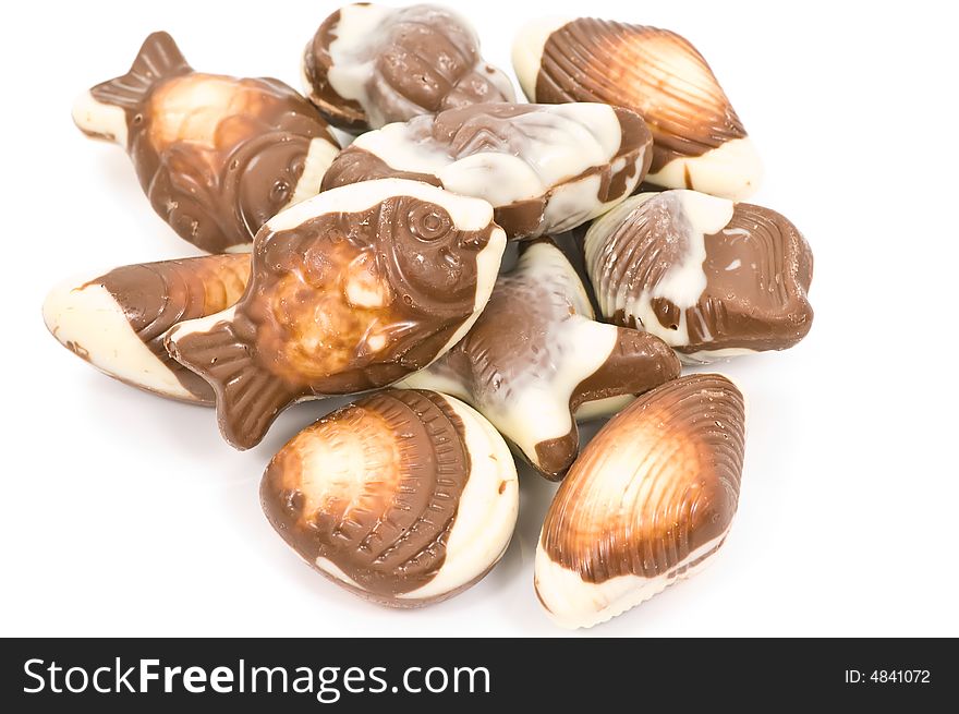 Milk and white chocolate pralines on white background