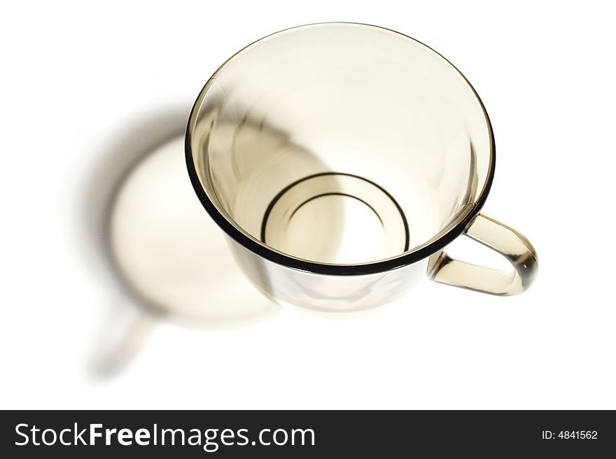 Transparent tea cup on light background