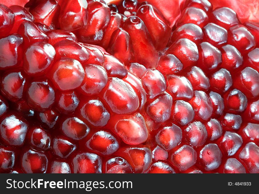 A background from ripe and fresh  pomegranate seeds. A background from ripe and fresh  pomegranate seeds