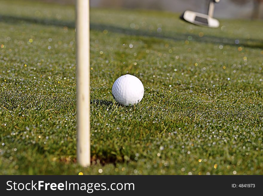 Golf ball on green with flag. Golf ball on green with flag