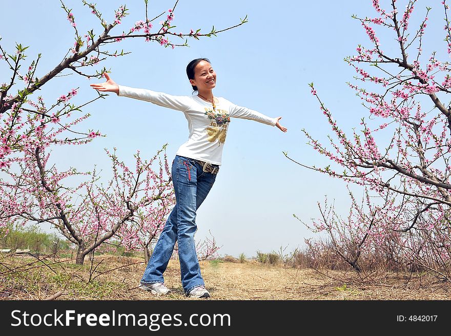 Girl in peach tree garden