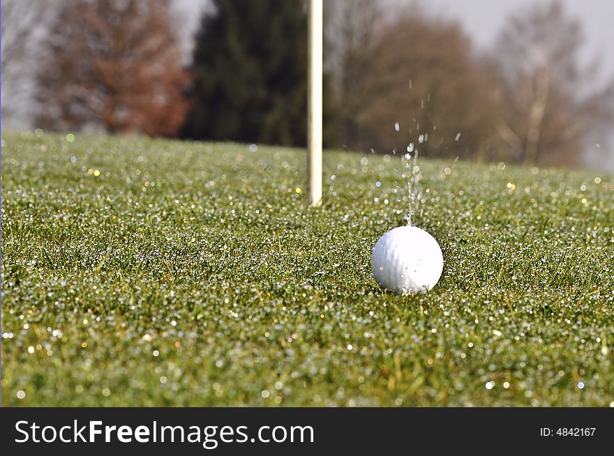 Golf ball on green with flag. Golf ball on green with flag