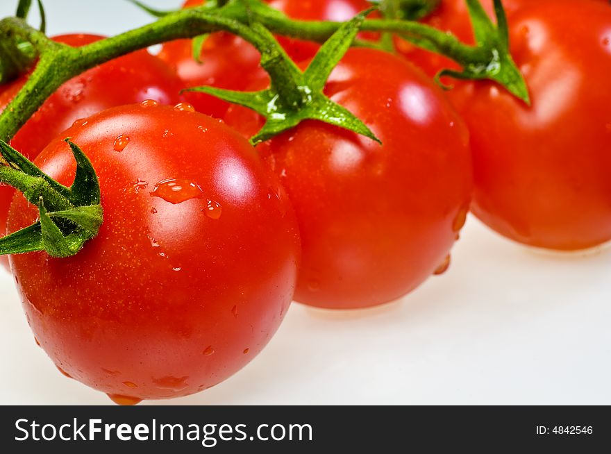 A bunch of tomatoes on white