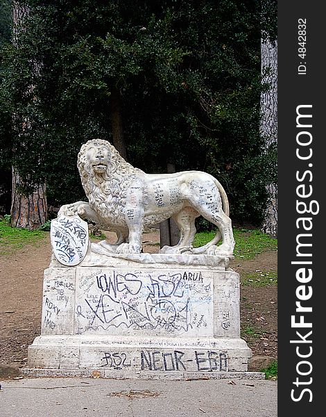 Graffiti covered lion in Piazza del Popolo in Rome, Italy. Graffiti covered lion in Piazza del Popolo in Rome, Italy