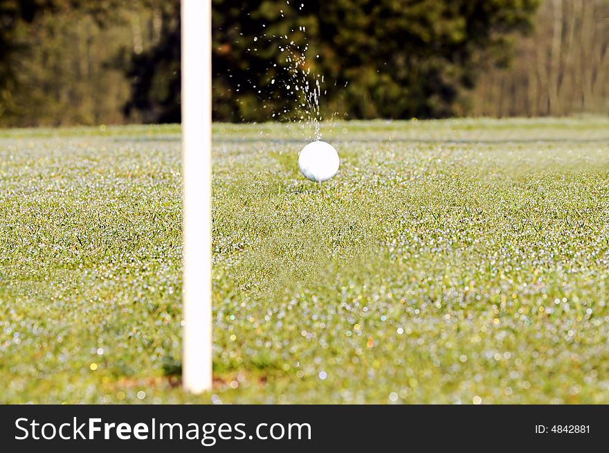 Golf ball on green with flag. Golf ball on green with flag